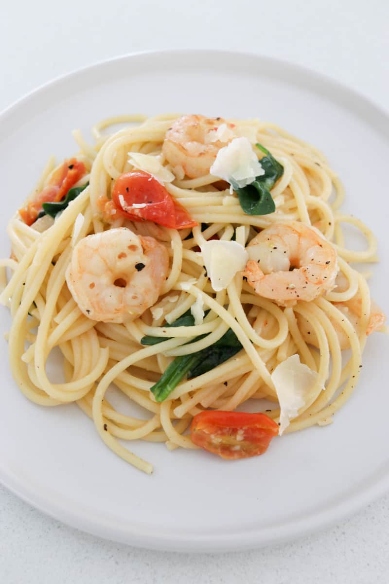 Prawn pasta with tomato and spinach  on plate
